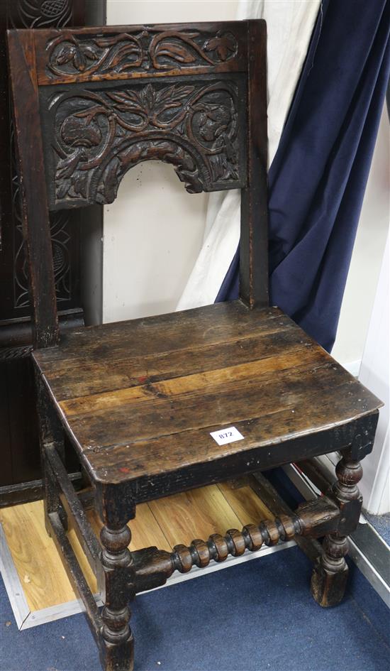 An early 18th century oak chair, with later seat